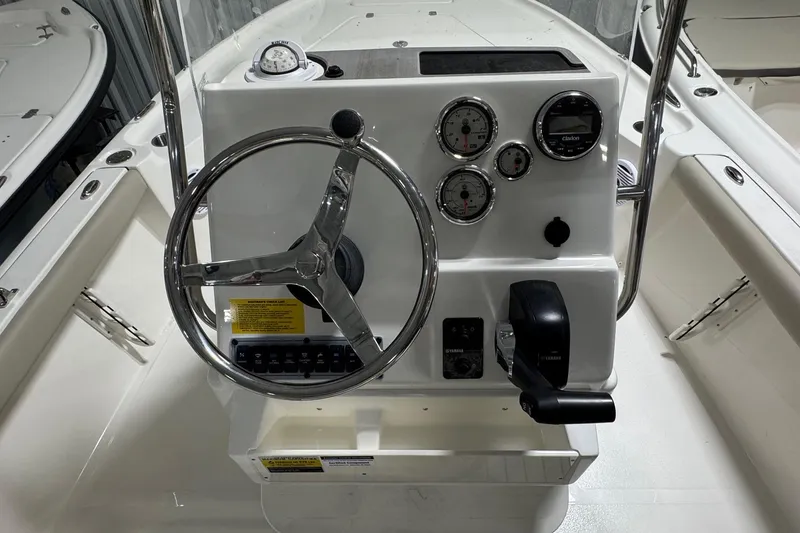 Slide: The Image of Steering console of 2026 Key West 188 Bay Reef boat with gauges and controls. - 12