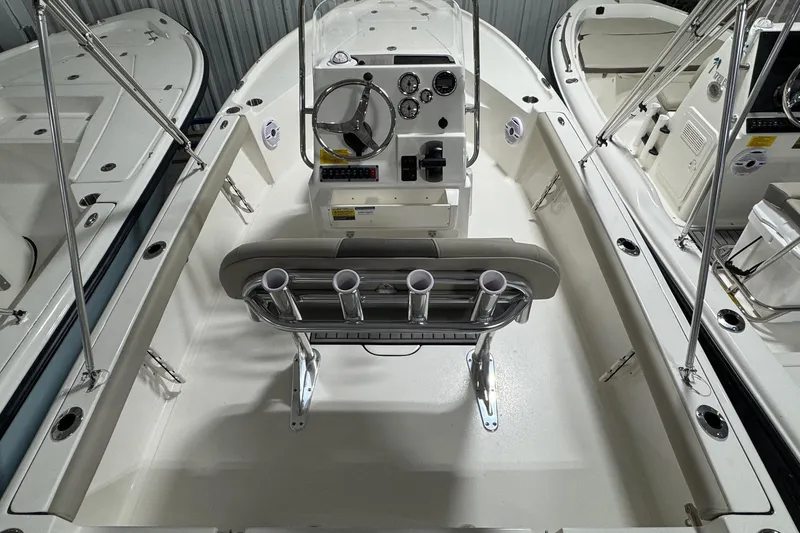 Slide: The Image of 2026 Key West 188 Bay Reef boat interior with steering console and rod holders. - 17