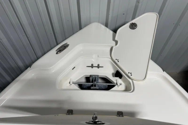 Slide: The Image of 2026 Key West 188 Bay Reef boat anchor compartment with open hatch in storage. - 7