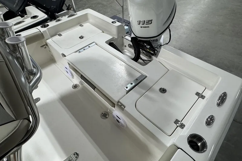 Slide: The Image of 2026 Key West 188 Bay Reef boat interior with Yamaha 115 engine, featuring storage compartments. - 13