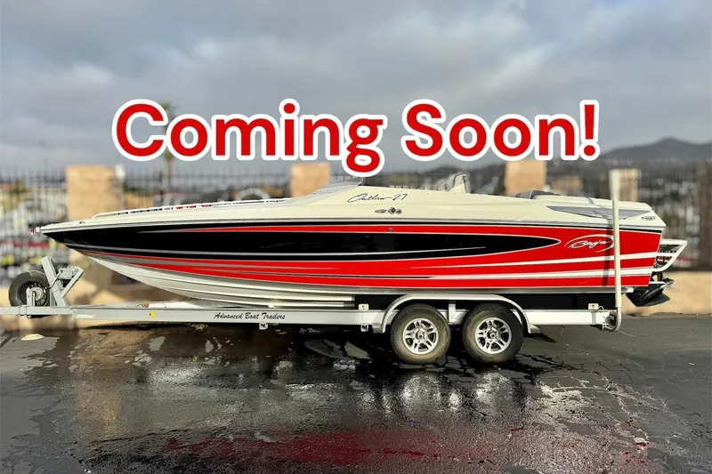 The Image of 2019 Baja 27 Outlaw speedboat on trailer, red and black design, parked outdoors. - 0