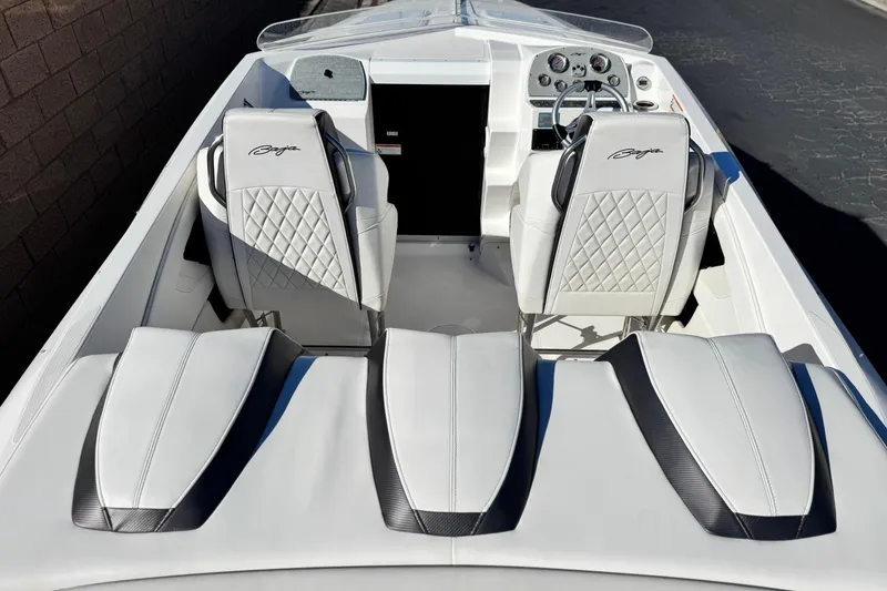 Slide: The Image of 2019 Baja 27 Outlaw boat interior with white leather seats and dashboard view. - 10