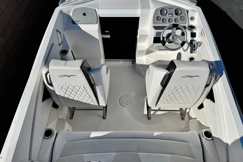 Slide: The Image of 2019 Baja 27 Outlaw boat interior with white seating and modern dashboard. - 11