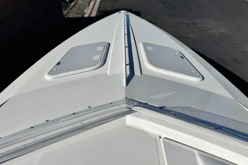 Slide: The Image of 2019 Baja 27 Outlaw boat deck with sleek design and dual hatches. - 12