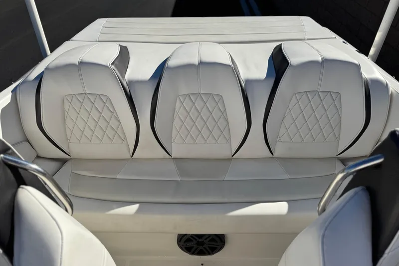 Slide: The Image of 2019 Baja 27 Outlaw boat interior with white quilted seats and black accents. - 13
