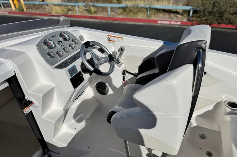 Slide: The Image of 2019 Baja 27 Outlaw boat cockpit with steering wheel and control panel. - 21
