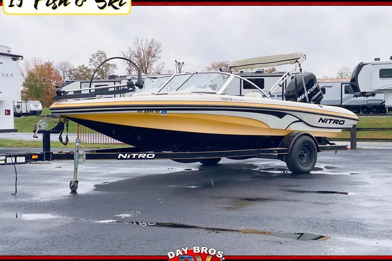 The Image of 2008 Nitro 189 Sport boat on trailer, parked outdoors on a cloudy day. - 0