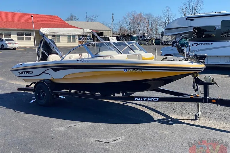 Slide: The Image of 2008 Nitro 189 Sport boat on trailer in parking lot, sunny day. - 24