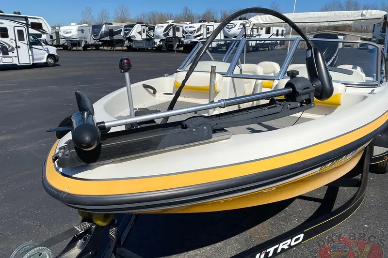 Slide: The Image of 2008 Nitro 189 Sport boat with trolling motor, parked near RVs in a lot. - 26