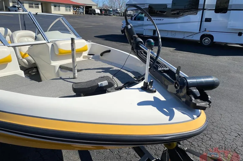Slide: The Image of 2008 Nitro 189 Sport boat with trolling motor, parked near RV. - 27