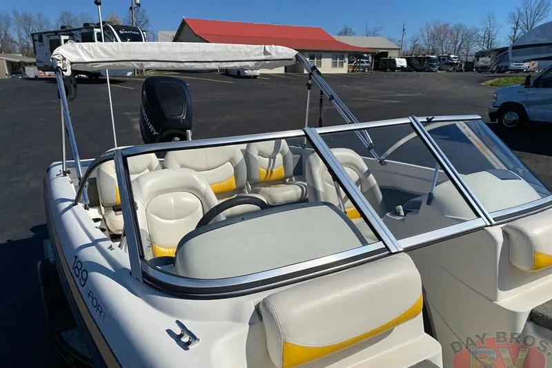 Slide: The Image of 2008 Nitro 189 Sport boat with windshield and seating, parked outdoors. - 30