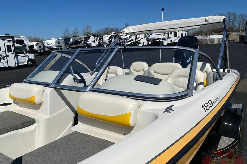 Slide: The Image of 2008 Nitro 189 Sport boat with yellow accents, parked near RVs under a clear blue sky. - 32