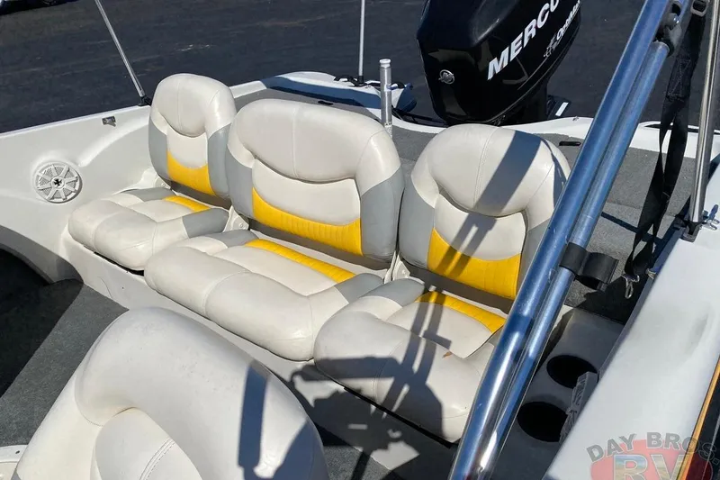 Slide: The Image of 2008 Nitro 189 Sport boat interior with white and yellow seating, featuring a Mercury engine. - 34