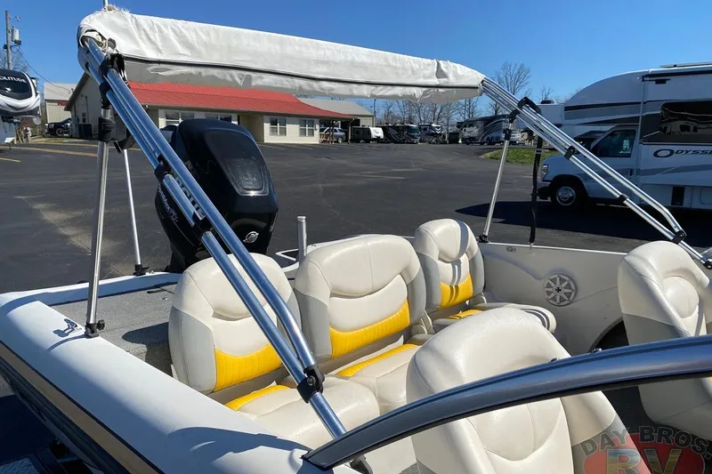 Slide: The Image of 2008 Nitro 189 Sport boat with white and yellow seating, parked outdoors. - 35