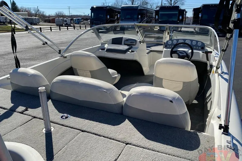 Slide: The Image of 2008 Nitro 189 Sport boat interior with seating and dashboard, parked outdoors. - 37