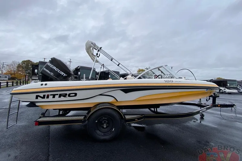 Slide: The Image of 2008 Nitro 189 Sport boat with Mercury engine on trailer, parked outdoors. - 4