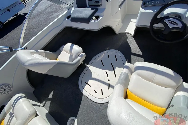 Slide: The Image of 2008 Nitro 189 Sport boat interior with white and yellow seating, steering wheel, and dashboard. - 40