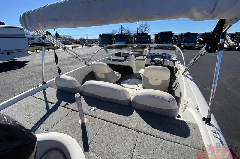 Slide: The Image of 2008 Nitro 189 Sport boat interior with seating and steering wheel, parked outdoors. - 45