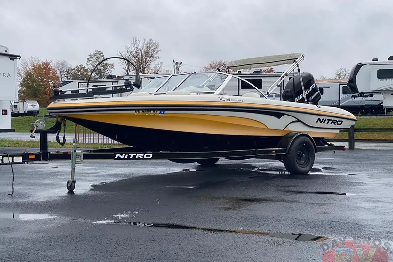 Slide: The Image of 2008 Nitro 189 Sport boat on trailer, parked outdoors on a rainy day. - 7
