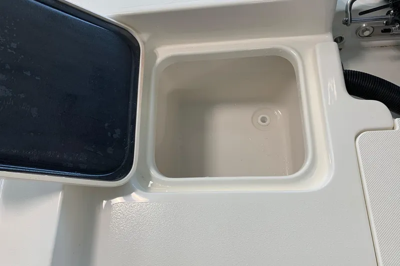 Slide: The Image of 2026 Key West 188 Bay Reef boat storage compartment with black lid. - 12