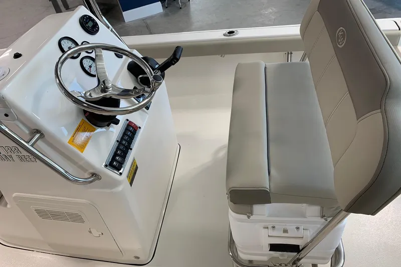 Slide: The Image of 2026 Key West 188 Bay Reef boat console with steering wheel and cushioned seating. - 6