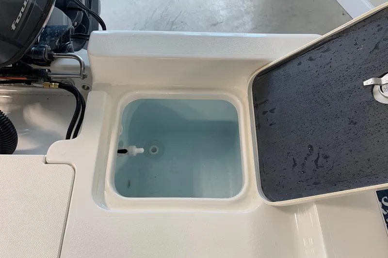 Slide: The Image of Livewell compartment on 2026 Key West 188 Bay Reef boat, open lid, showing interior. - 11