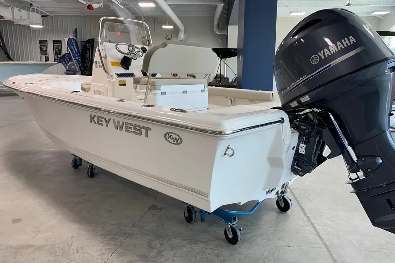 Slide: The Image of 2026 Key West 188 Bay Reef boat with Yamaha outboard motor in showroom. - 2
