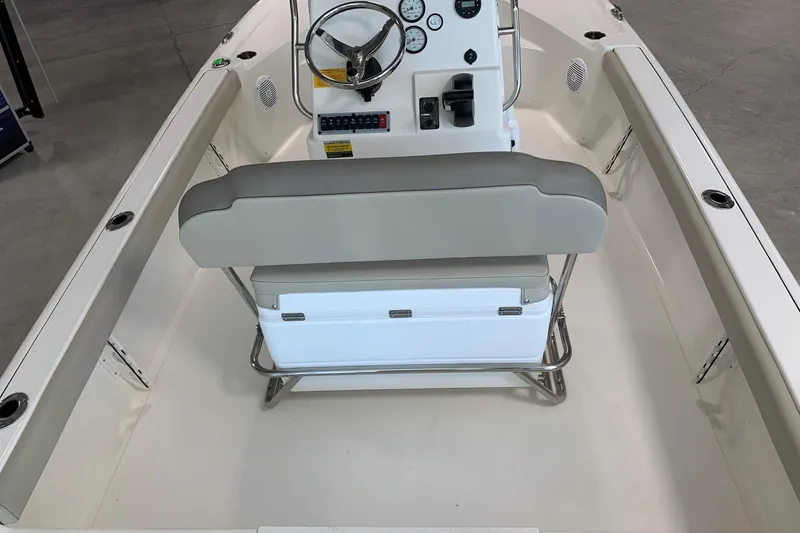 Slide: The Image of 2026 Key West 188 Bay Reef boat interior with steering console and cushioned seating. - 5