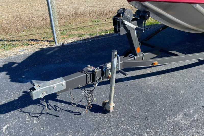 Slide: The Image of Trailer hitch of a 2017 Ranger RT188 boat on asphalt near a chain-link fence. - 16