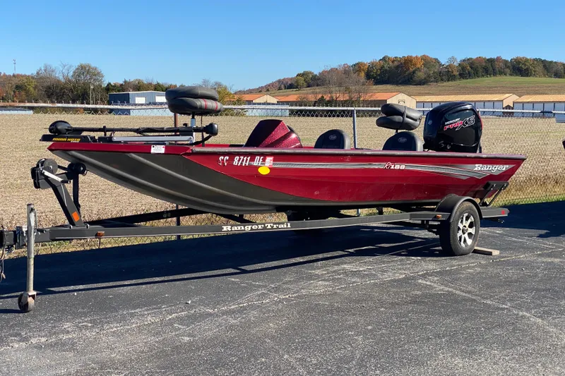Slide: The Image of 2017 Ranger RT188 boat on trailer, parked outdoors on sunny day. - 17