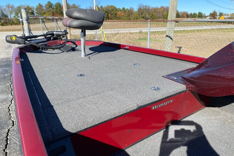 Slide: The Image of 2017 Ranger RT188 boat with gray deck and red exterior, parked outdoors. - 21