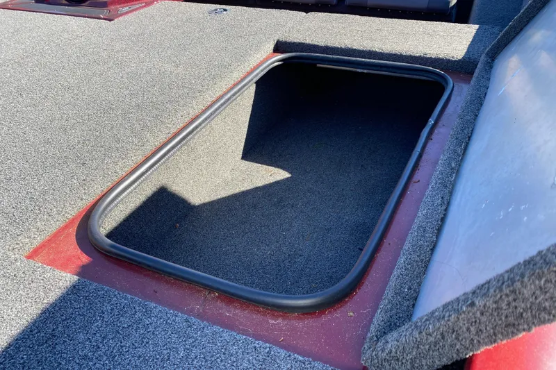 Slide: The Image of 2017 Ranger RT188 boat storage compartment with open lid, featuring carpeted interior. - 22