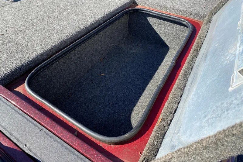 Slide: The Image of 2017 Ranger RT188 boat storage compartment with open lid, showing carpeted interior. - 26