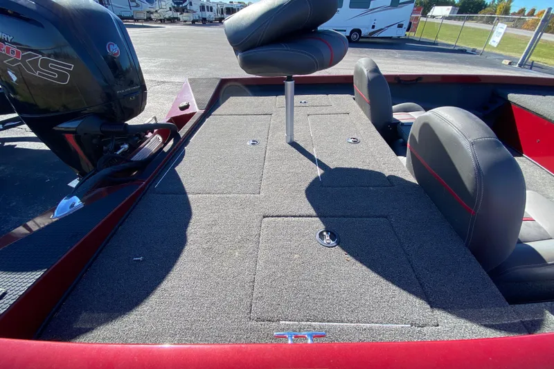 Slide: The Image of 2017 Ranger RT188 boat interior with seating and motor, parked outdoors. - 31