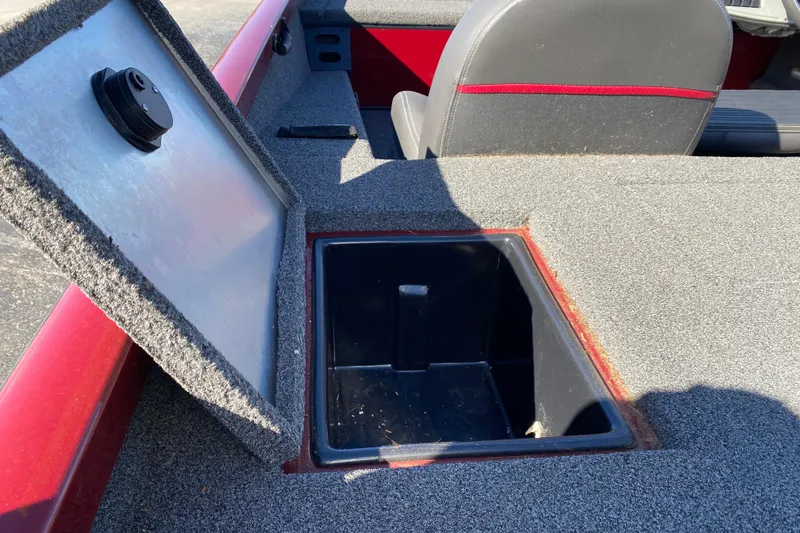 Slide: The Image of 2017 Ranger RT188 boat storage compartment with open lid, gray interior, and red accents. - 36