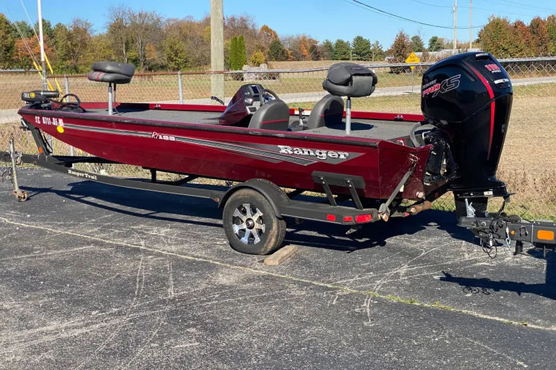 Slide: The Image of 2017 Ranger RT188 boat on trailer, red color, parked outdoors. - 38
