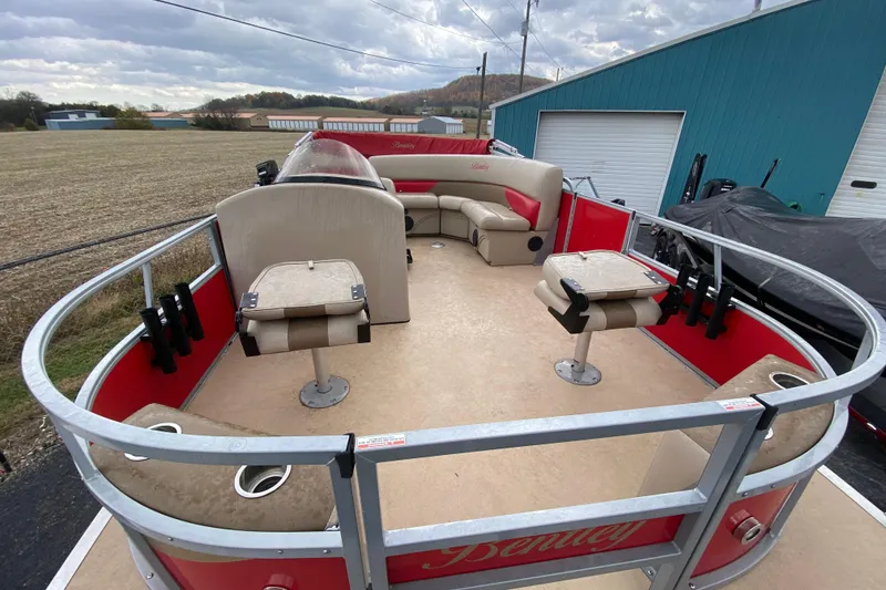 Slide: The Image of 2018 Bentley Pontoons 200 Fish boat with red and beige seating, docked outdoors. - 12