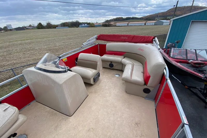 Slide: The Image of 2018 Bentley Pontoons 200 Fish with red and beige seating, parked outdoors. - 17