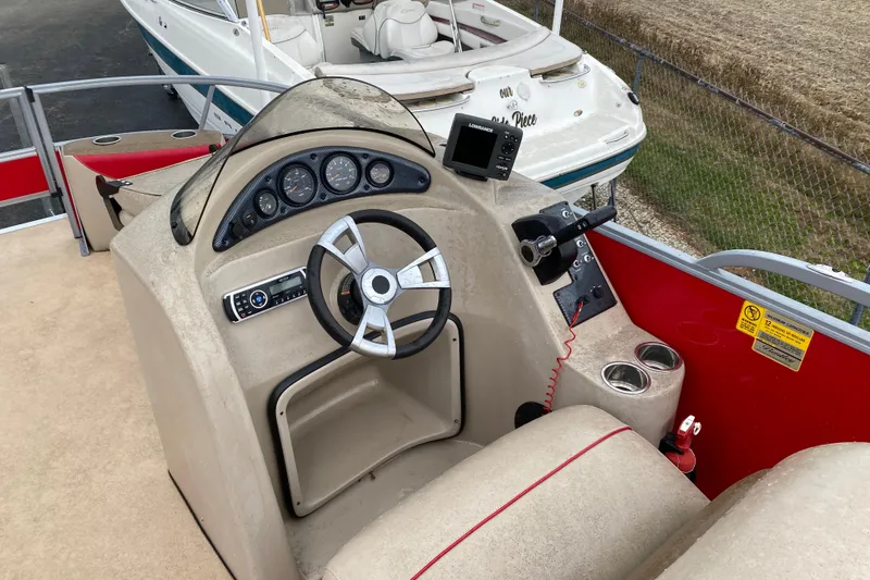 Slide: The Image of 2018 Bentley Pontoons 200 Fish dashboard with steering wheel and controls. - 20