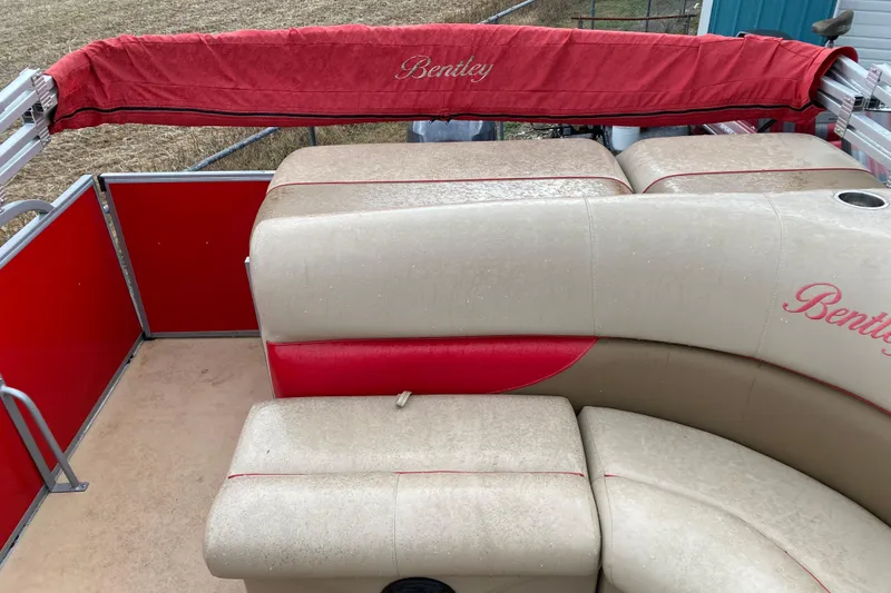 Slide: The Image of 2018 Bentley Pontoons 200 Fish with beige and red seating, outdoor setting. - 22