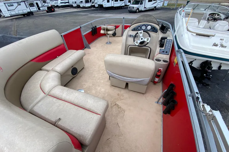 Slide: The Image of 2018 Bentley Pontoons 200 Fish interior with beige seating and control panel. - 24