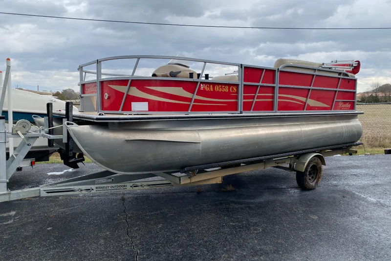 Slide: The Image of 2018 Bentley Pontoons 200 Fish on trailer, red and silver design, outdoor setting. - 7