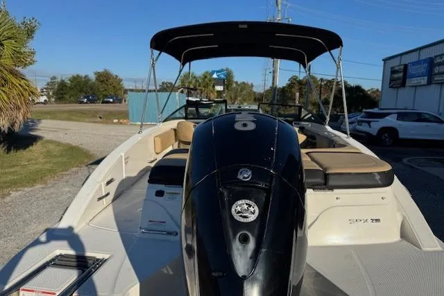 Slide: The Image of 2022 Sea Ray SPX 210 Outboard boat with black motor and canopy, parked outdoors. - 10