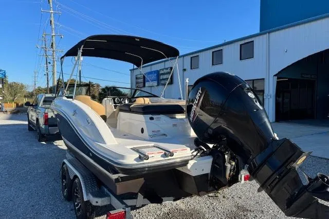 Slide: The Image of 2022 Sea Ray SPX 210 Outboard boat on trailer, parked outside a building. - 11
