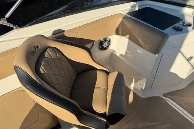 Slide: The Image of 2022 Sea Ray SPX 210 Outboard boat interior with tan leather seating and cup holders. - 16