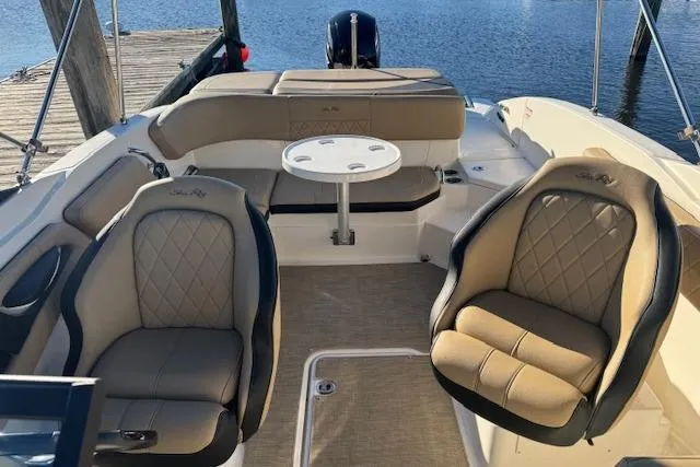 Slide: The Image of 2022 Sea Ray SPX 210 Outboard boat interior with luxurious seating and table. - 17
