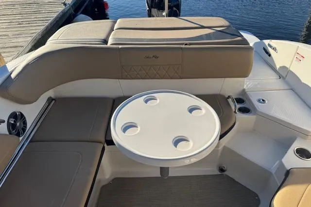 Slide: The Image of 2022 Sea Ray SPX 210 Outboard boat interior with seating and round table. - 20