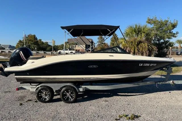 Slide: The Image of 2022 Sea Ray SPX 210 Outboard boat on trailer, parked outdoors. - 3