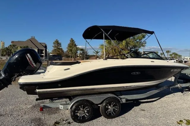 Slide: The Image of 2022 Sea Ray SPX 210 Outboard boat on trailer, parked outdoors under clear sky. - 6