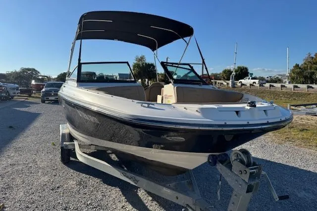 Slide: The Image of 2022 Sea Ray SPX 210 Outboard boat on trailer, parked outdoors under clear sky. - 9